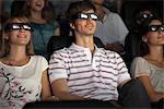 Audience enjoying 3-D movie in theater