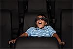 Boy enjoying 3-D movie in theater