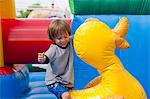 Boy playing in bouncy castle