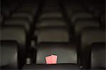 Movie tickets and empty seats in movie theater