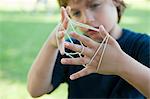 Boy playing cat's cradle, focus on hands