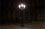 Street lamp illuminated at night in Place de l'Hotel de Ville, Paris, France
