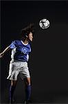 Japanese Young Sportswoman Hitting Soccer