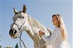 Woman Brushing Horse