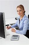 Young woman sitting at desk in office