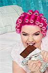 Portrait of young woman eating chocolate bar