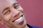 Tilt portrait of a happy African American man over colored background