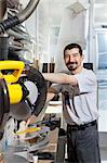 Portrait of a Hispanic employee using circular saw