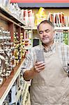 Mature salesperson reading instructions in hardware store