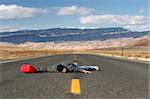 man out of gas in the middle of nowhere, collapsed in the middle of the road while looking for a gas station