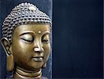 Bronze Buddha head on a black background - copy space