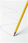 pencil moving on a white surface and drawing a line