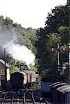 Steam train pulling carriages away from station, severn valley railway, bewdley, uk