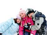 Three children having fun in the fresh white snow