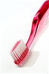 Pink toothbrush isolated against white