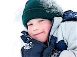 Young boy playing in fresh powder snow