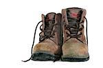Dirty old brown leather steel toe capped workmans boots covered in mud, against a white background.