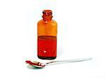 Bottle of cough syrup and a spoon on white background