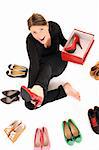 A picture of a young woman trying on new pair of heels over white background