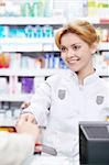 The pharmacist sells the medicine in a pharmacy