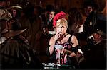 Bluffing bar maid with playing cards in old west saloon