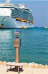 A metallic coin operated viewer for tourists to look at the white holiday cruise liners in the port of Kusadasi, Turkey, on the Aegean Coast