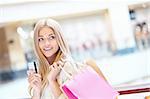 Beautiful girl with shopping bags and credit card