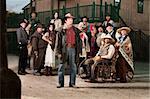 Tough cowboy with group of people in old west costumes