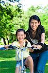 asian mother Teaching daughter To Ride A bicycle