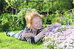 Young girl enjoys some flowers in the garden