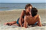 guy kiss his girlfriend on the beach