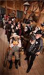 Serious people in old west saloon pull out their weapons