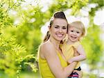 Portrait of smiling mother and baby girl outdoors