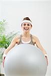 Healthy woman holding fitness ball