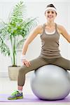 Fitness woman sitting on fitness ball