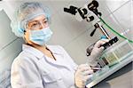 A female doctor examines a sample.   Could be useful for medicine, hospital, research and development, clinical studies, forensics, science etc