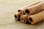 Cinnamon sticks on wooden background