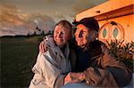 Handsome senior couple looking toward a sunset outside