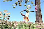 a man made of euro banknotes and coin is leaning against a tree at the top of a hill in a meadow of plants with one euro coin instead of leaves in a blue sky background