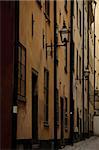 Antique buildings in a dark and narrow alley in Stockholm old town (Gamla stan), Sweden