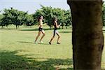 Sports and fitness with two female teenagers exercising in city park