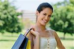 Consumerism, portrait of happy young woman smiling with shopping bags