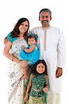 Happy traditional Indian family in traditional Indian costume standing on white background