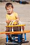 boy toddler is having fun in the playground