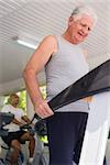 People and sports, elderly man working out on treadmill in fitness gym