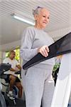 People and sports, elderly woman working out on treadmill in fitness gym