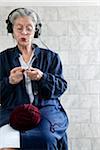 Woman Knitting and Listening to Headphones