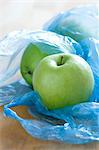 Green apples in plastic bags