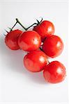 Several vine tomatoes with drops of water