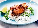 Salmon kebab with honey and lime on a bed of rice